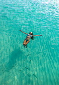 High angle view of woman swimming in sea