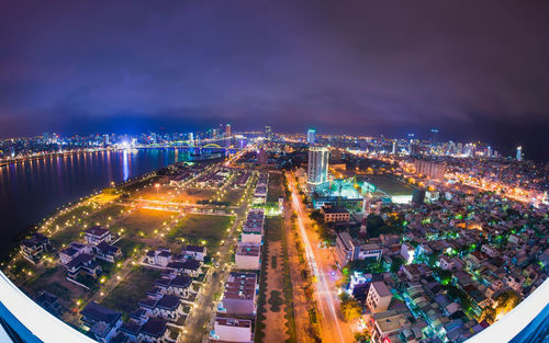 High angle view of illuminated cityscape against sky at night