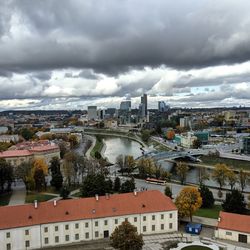 High angle view of buildings and river against sky