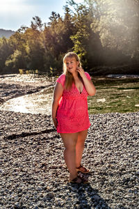 Portrait of beautiful woman standing on land