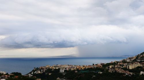 Panoramic view of buildings and sea against sky