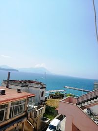 High angle view of buildings by sea against sky