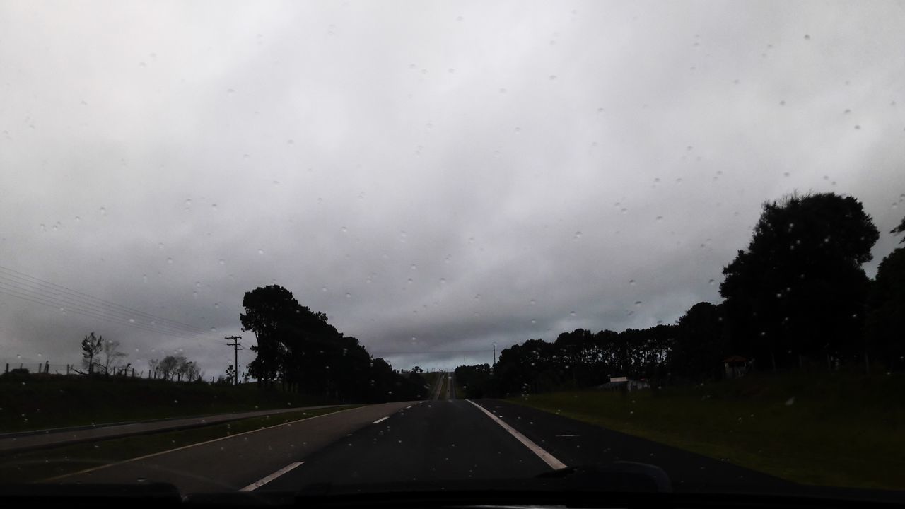 ROAD SEEN THROUGH WET CAR WINDSHIELD