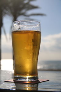 Close-up of beer glass on table