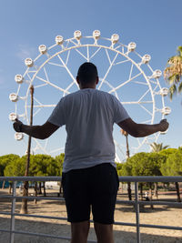 Rear view of man standing against sky