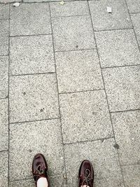 Low section of man standing on sidewalk