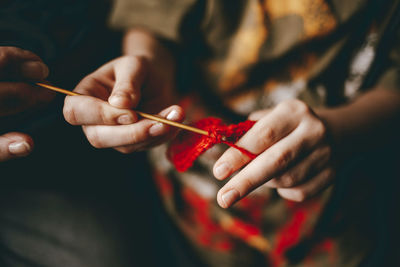 Midsection of woman weaving