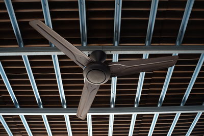 Low angle view of electric fan on ceiling