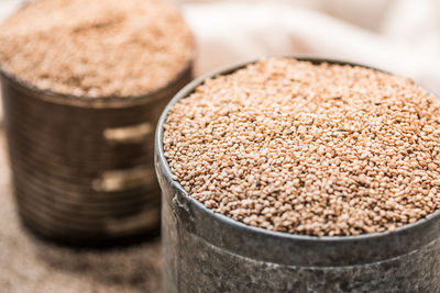 Close-up of sesame seeds in containers