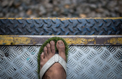 Low section of person standing on train