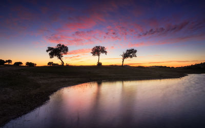 Scenic view of lake against sky during sunset