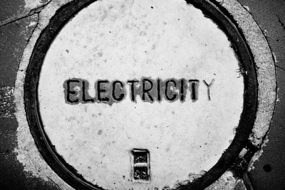 High angle view of text engraved on manhole