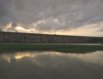 Scenic view of river by building against sky