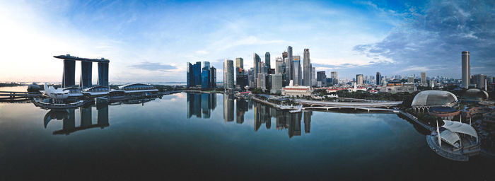 Panoramic view of singapore city buildings against sky