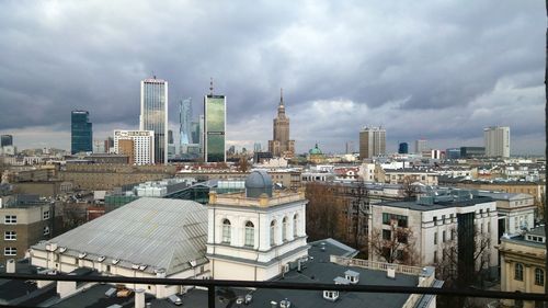 Cityscape against cloudy sky