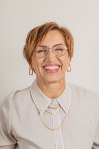 Portrait of young woman against white background