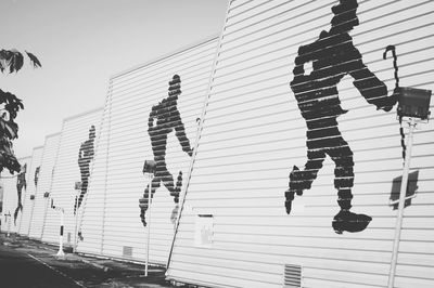 Low angle view of men against clear sky