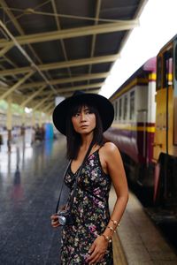 Mature woman standing at railroad station platform