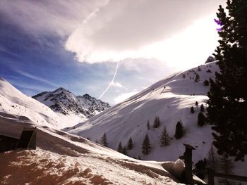 Scenic view of snow covered mountains against sky