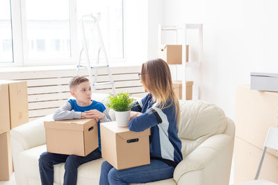 Young woman holding camera in box