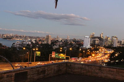 Illuminated buildings in city against sky at night