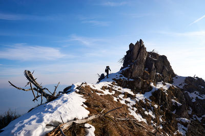 Low angle view of snow on mountain against sky