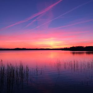 Scenic view of lake against romantic sky at sunset