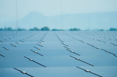 Close-up of power lines against blue sky