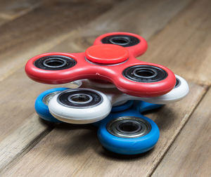 High angle view of colorful fidget spinners on wooden table