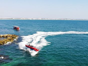 High angle view of boat sailing in sea against clear sky