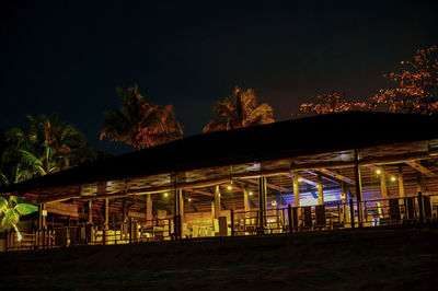 Illuminated building against sky at night