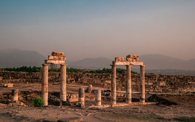 Ancient building against sky during sunset