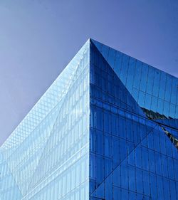 Low angle view of modern building against clear blue sky