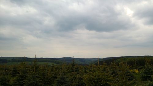 Scenic view of landscape against cloudy sky