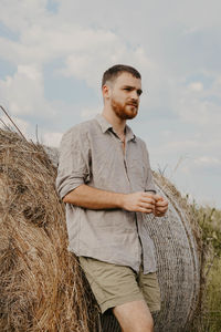 Man standing on field against sky
