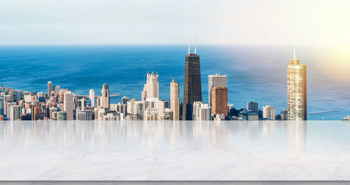 View of buildings in sea against sky