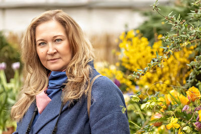 A middle-aged woman sniffs and admires tulips in the botanical garden.spring