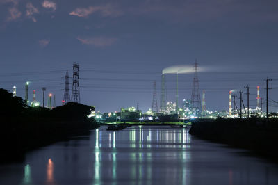 Illuminated city against sky at night