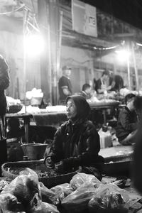 Woman sitting at market stall