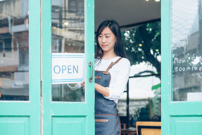 Young woman standing in front of a store