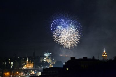 Low angle view of fireworks against sky at night