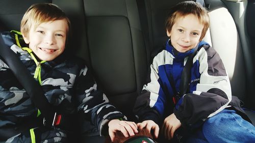 Portrait of smiling boy sitting in bus