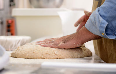 Midsection of man preparing at kitchen