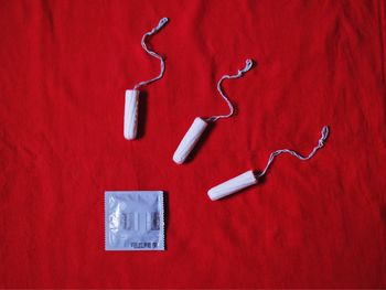 Directly above shot of tampons and condom on table