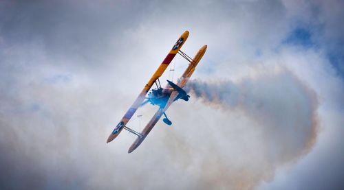 Low angle view of airplane flying in sky