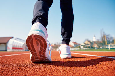 Runner feet running at sport stadium track