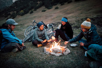 GROUP OF PEOPLE WITH FIRE ON THE BACKGROUND