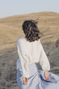 Rear view of woman looking at desert