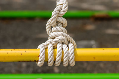 Close-up of rope tied on wood