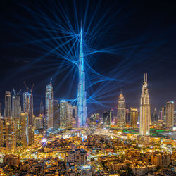 Illuminated cityscape against sky at night